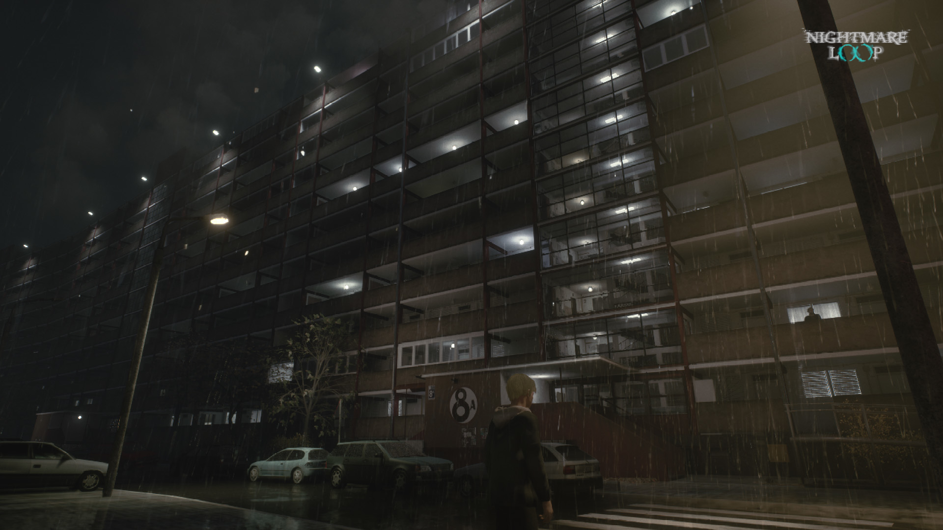 Towering Falowiec apartment block at night in the rain with a lone figure below
